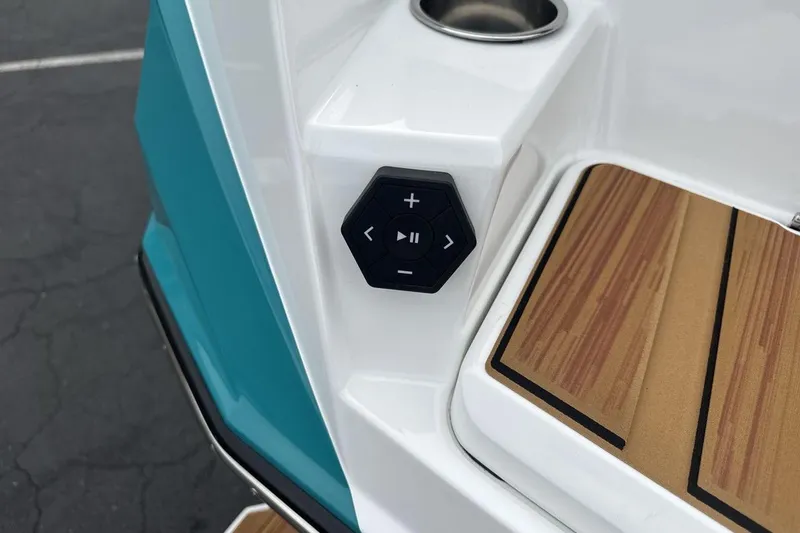 Slide: The Image of 2026 Supra SV boat control panel with teak flooring and cup holder. - 27