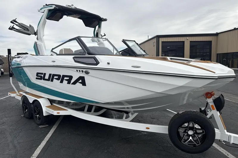 Slide: The Image of 2026 Supra SV boat on trailer, sleek design, parked outdoors. - 7