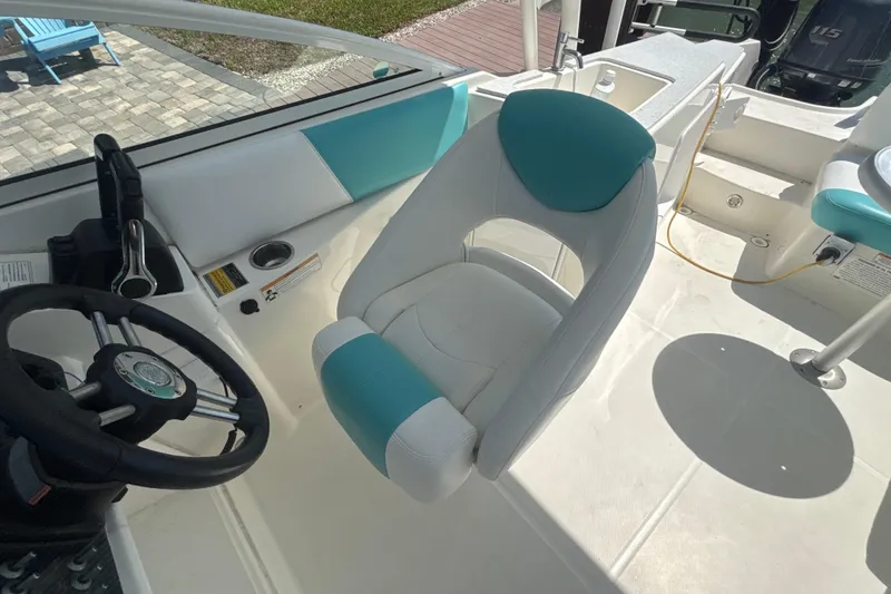 Slide: The Image of Interior of 2018 World Cat 230 SD boat with steering wheel and seating. - 10