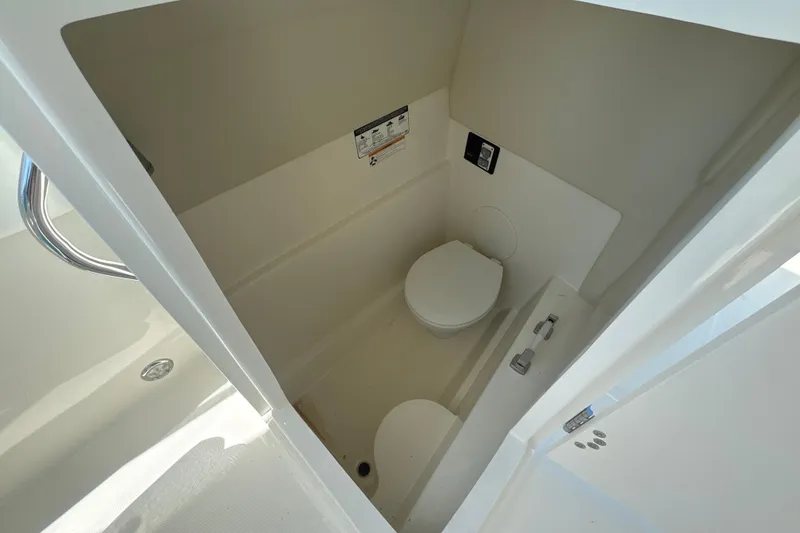 Slide: The Image of Interior view of 2018 World Cat 230 SD boat's compact bathroom area. - 12