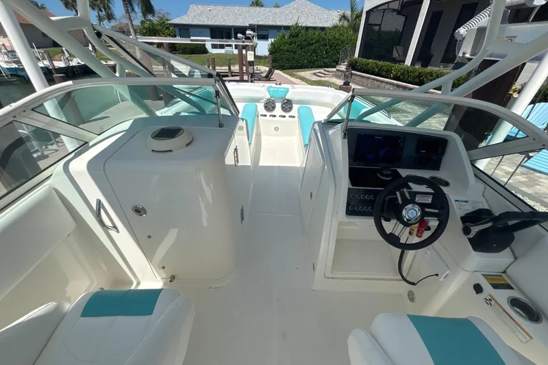 Slide: The Image of 2018 World Cat 230 SD boat interior with steering wheel and seating area. - 14