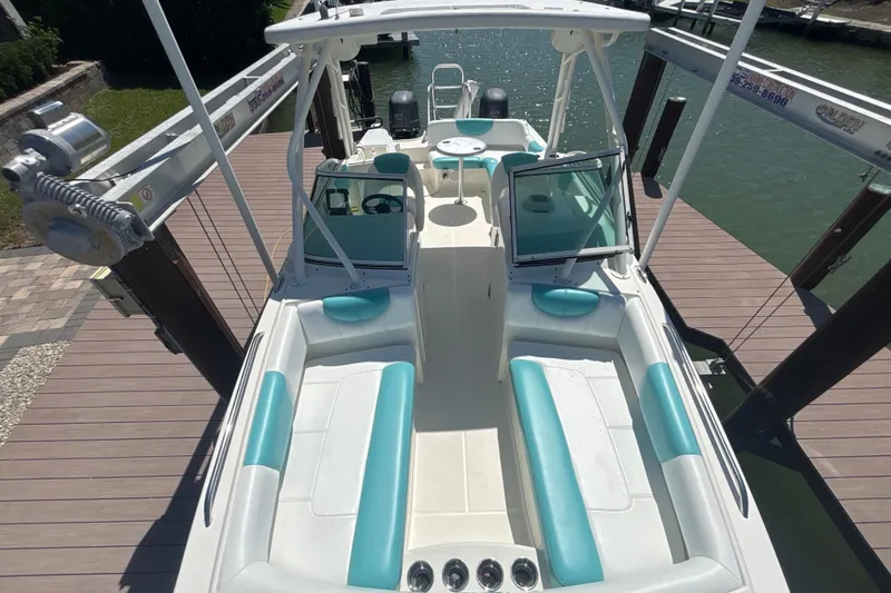 Slide: The Image of 2018 World Cat 230 SD boat docked, featuring spacious seating and dual engines. - 16