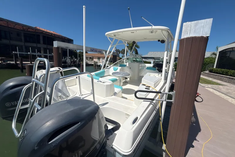 Slide: The Image of 2018 World Cat 230 SD boat docked with dual Yamaha engines, sunny day. - 19