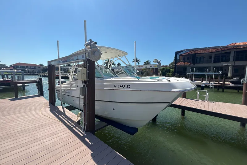 Slide: The Image of 2018 World Cat 230 SD boat docked on a sunny waterfront. - 3