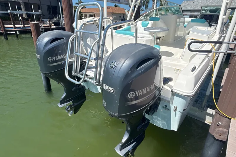 Slide: The Image of 2018 World Cat 230 SD boat with dual Yamaha 115 outboard motors docked. - 5
