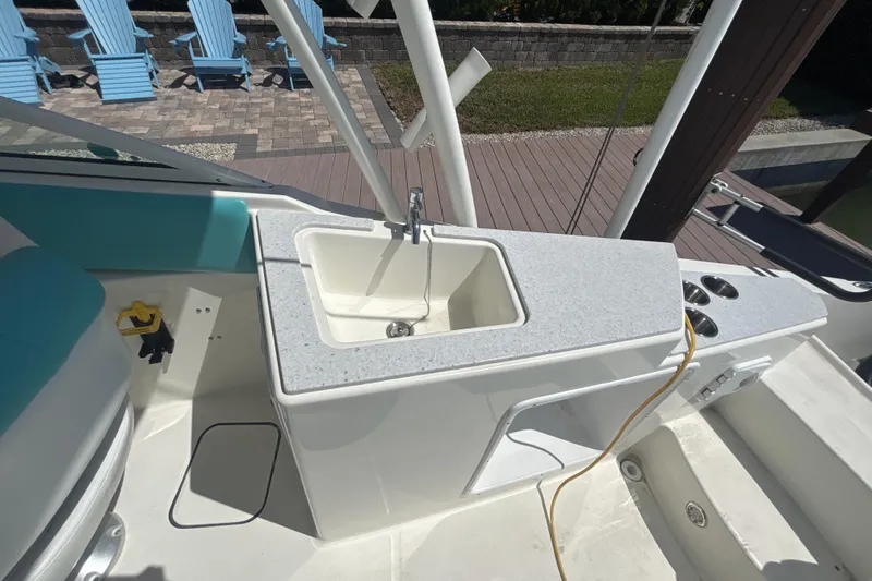 Slide: The Image of 2018 World Cat 230 SD boat interior with sink and seating area. - 8