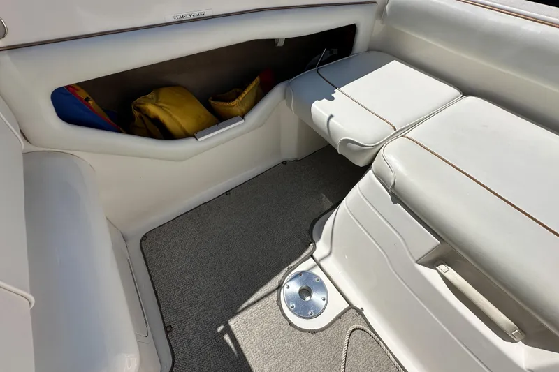 Slide: The Image of Interior of a 1998 Sea Ray 215 Express Cruiser with seating and storage. - 11
