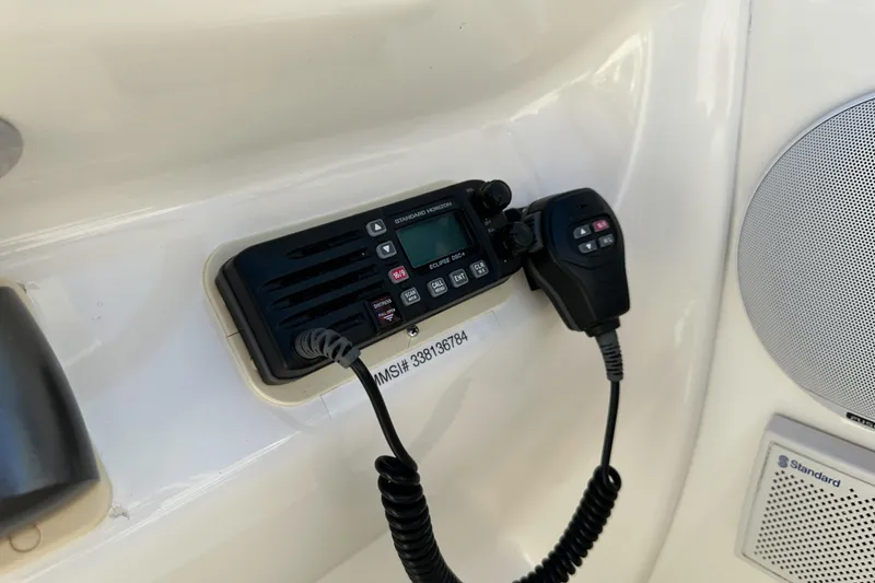 Slide: The Image of VHF radio and speaker on 1998 Sea Ray 215 Express Cruiser boat dashboard. - 27