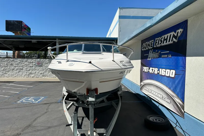 Slide: The Image of 1998 Sea Ray 215 Express Cruiser on trailer at Gone Fishin' Marine dealership. - 3