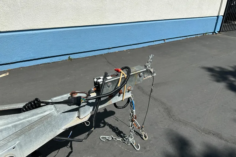 Slide: The Image of Trailer hitch of a 1998 Sea Ray 215 Express Cruiser on pavement. - 7