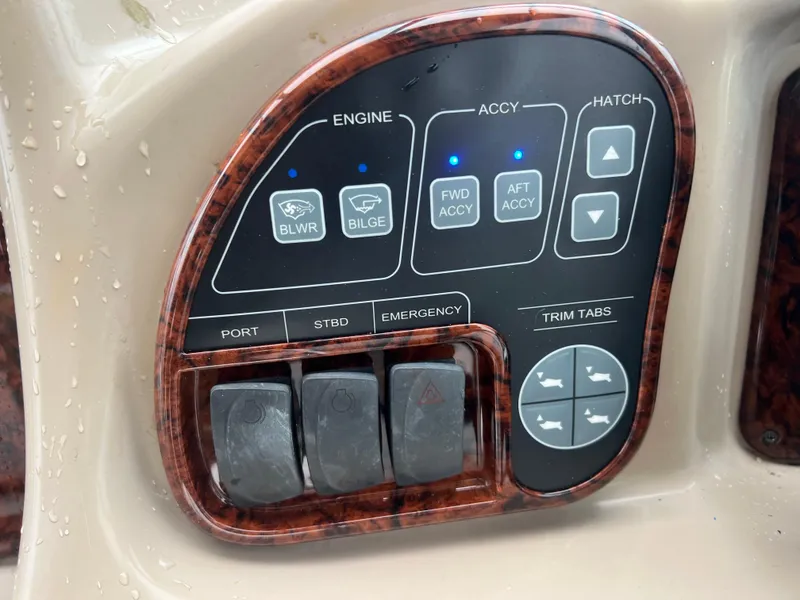 Slide: The Image of Control panel of a 2005 Sea Ray 340 Sundancer boat with various switches and buttons. - 15