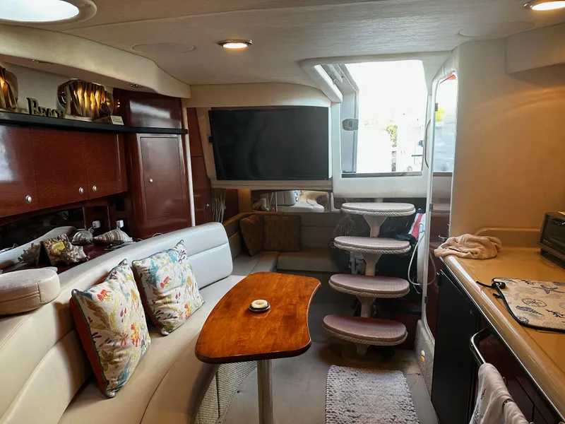 Slide: The Image of Interior of 2005 Sea Ray 340 Sundancer yacht with cozy seating and modern amenities. - 21