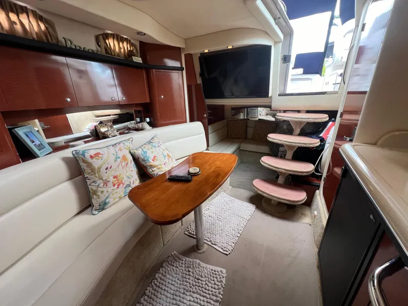 Slide: The Image of Luxurious interior of 2005 Sea Ray 340 Sundancer yacht with elegant seating and wooden table. - 24