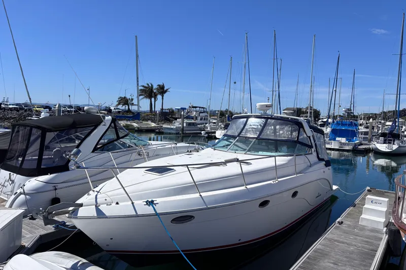 The Image of 2007 Rinker EX 370 boat docked in a marina with clear blue skies. - 0