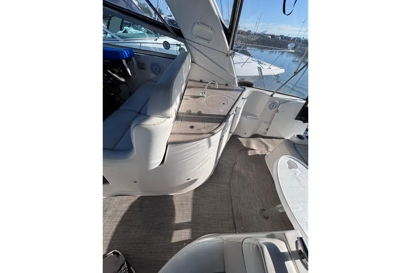 Slide: The Image of 2007 Rinker EX 370 boat interior with seating and table, docked at marina. - 10