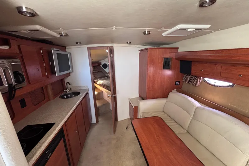 Slide: The Image of Interior of 2007 Rinker EX 370 yacht with kitchenette, seating, and sleeping area. - 11