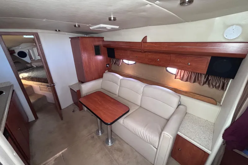 Slide: The Image of Interior of 2007 Rinker EX 370 yacht with cozy seating and wooden cabinetry. - 14