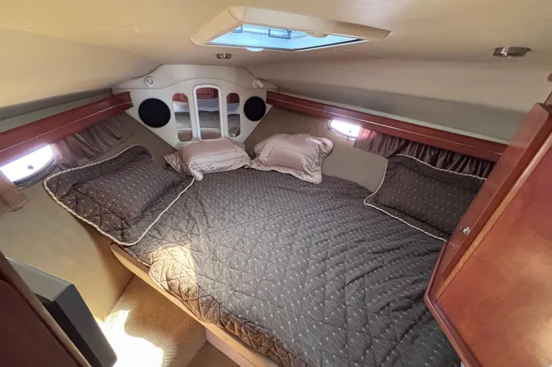 Slide: The Image of Cozy cabin interior of 2007 Rinker EX 370 with comfortable bedding and natural light. - 16