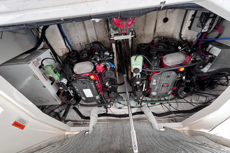 Slide: The Image of Engine compartment of a 2007 Rinker EX 370 boat, showcasing dual engines and mechanical components. - 22