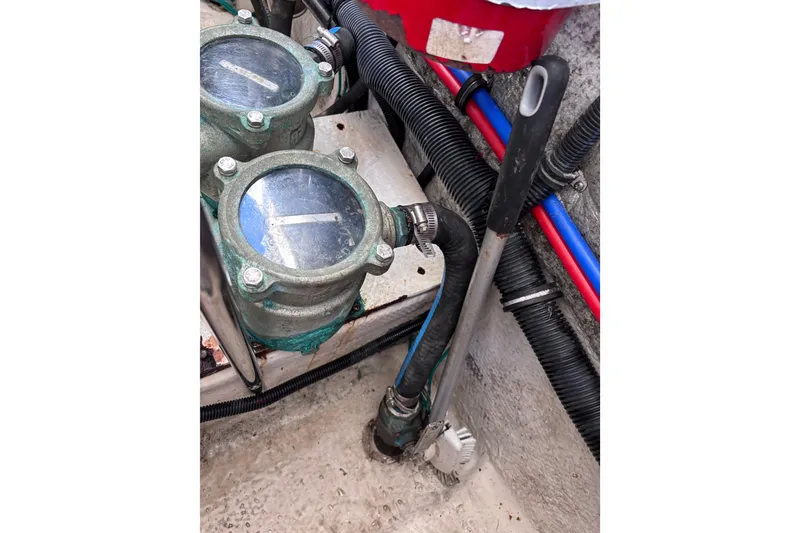 Slide: The Image of Engine components of a 2007 Rinker EX 370 boat, featuring belts and pulleys. - 34