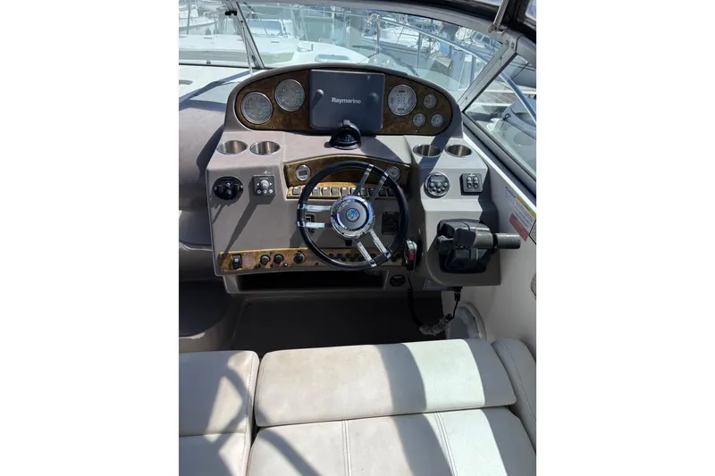 Slide: The Image of 2007 Rinker EX 370 boat dashboard with steering wheel and navigation controls. - 4