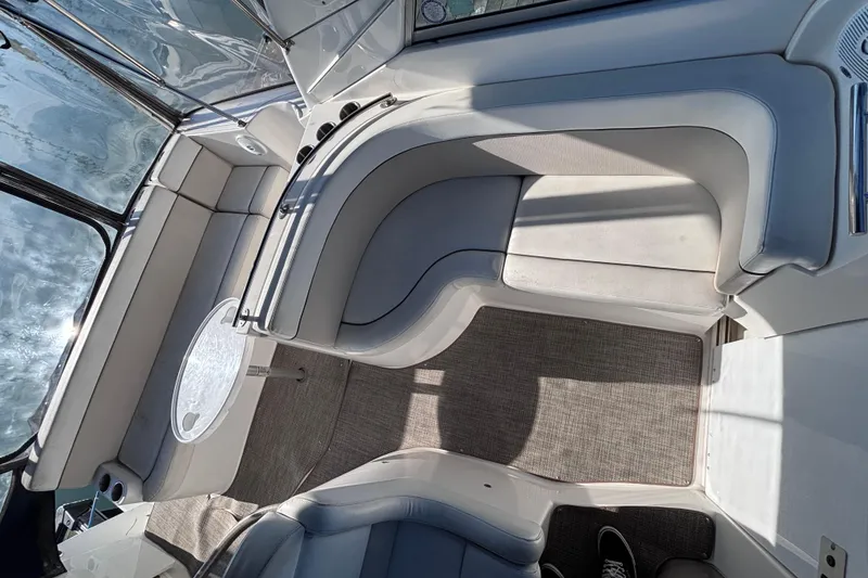 Slide: The Image of Interior of a 2007 Rinker EX 370 boat with cushioned seating and carpeted floor. - 7