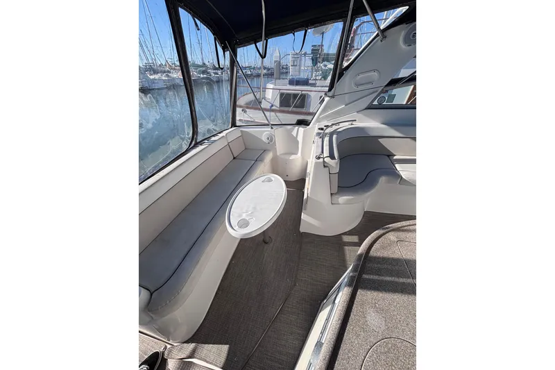 Slide: The Image of 2007 Rinker EX 370 boat interior with seating and table, docked at marina. - 9