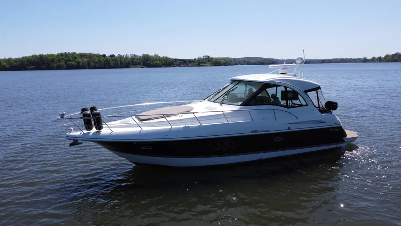 Slide: The Image of 2009 Cruisers Yachts 420 Sports Coupe on calm lake waters. - 16