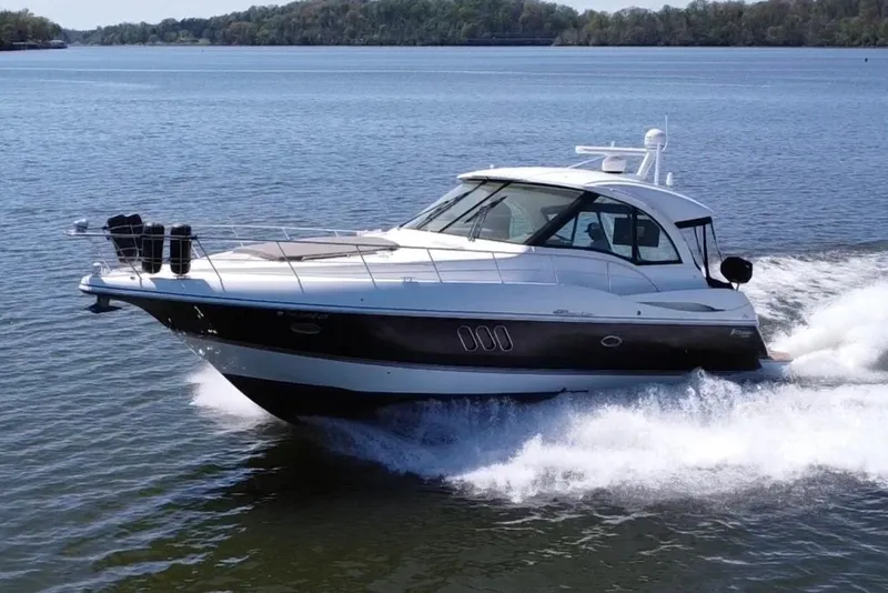 Slide: The Image of 2009 Cruisers Yachts 420 Sports Coupe cruising on a serene lake. - 2