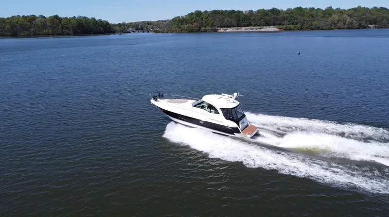 Slide: The Image of 2009 Cruisers Yachts 420 Sports Coupe cruising on a serene lake. - 20
