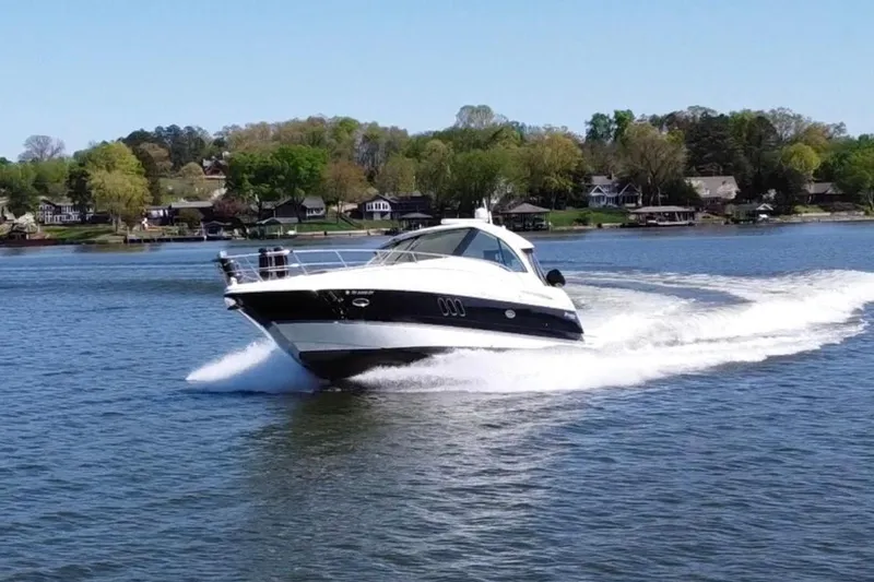 Slide: The Image of 2009 Cruisers Yachts 420 Sports Coupe cruising on a serene lake under clear skies. - 3