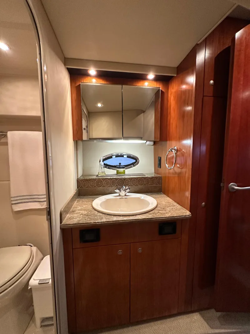 Slide: The Image of 2009 Cruisers Yachts 420 Sports Coupe bathroom with wood cabinetry and modern fixtures. - 31