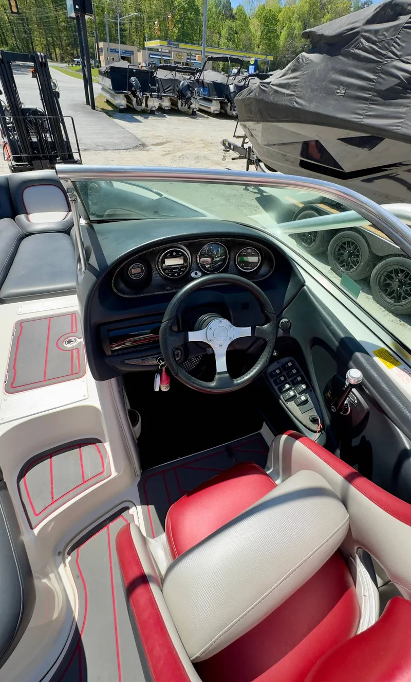 Slide: The Image of Interior of a 2005 Centurion Avalanche C4 boat with red and gray seating. - 10