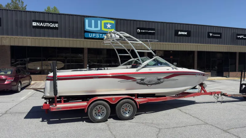 Slide: The Image of 2005 Centurion Avalanche C4 boat on trailer outside store. - 2