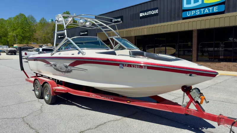 Slide: The Image of 2005 Centurion Avalanche C4 boat on red trailer in front of store. - 4