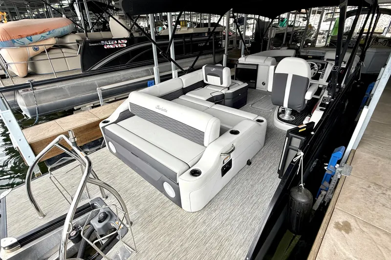 Slide: The Image of 2023 Barletta Corsa 23U pontoon boat interior with seating and helm station. - 12