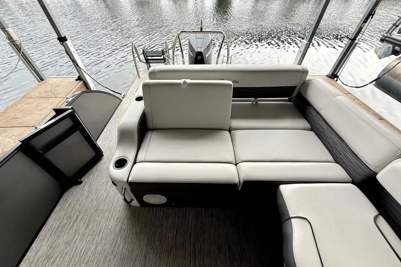 Slide: The Image of 2023 Barletta Corsa 23U pontoon boat interior with plush seating and water view. - 17