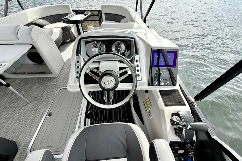 Slide: The Image of 2023 Barletta Corsa 23U boat interior with modern steering and navigation system. - 19