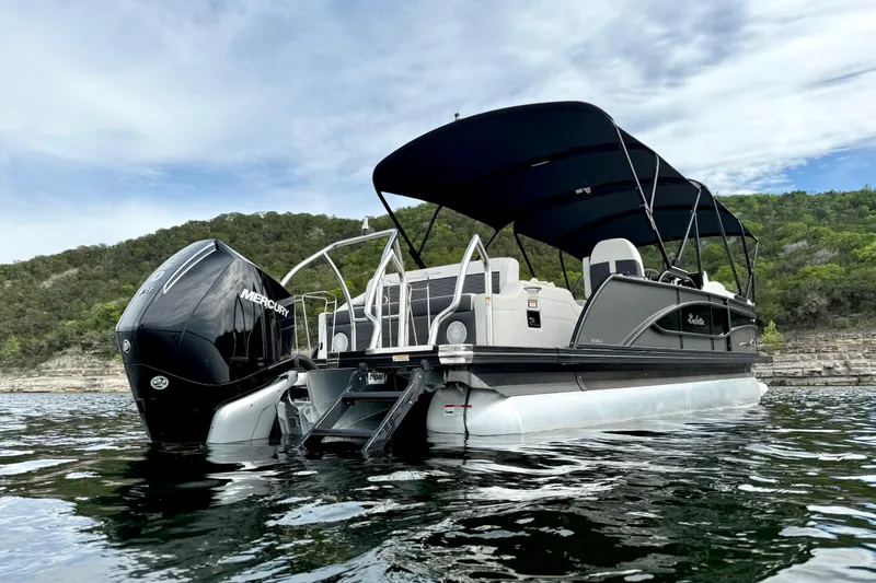 Slide: The Image of 2023 Barletta Corsa 23U pontoon boat on water, featuring a Mercury outboard motor. - 4