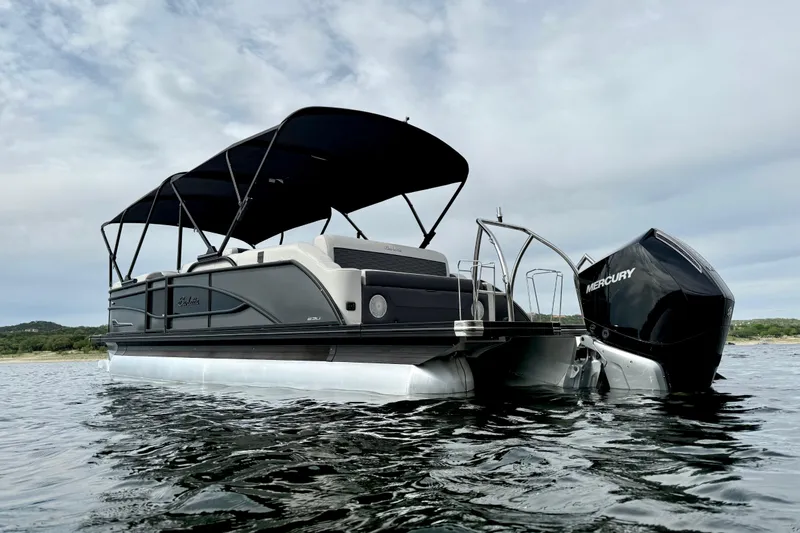 Slide: The Image of 2023 Barletta Corsa 23U pontoon boat with Mercury engine on calm water. - 6