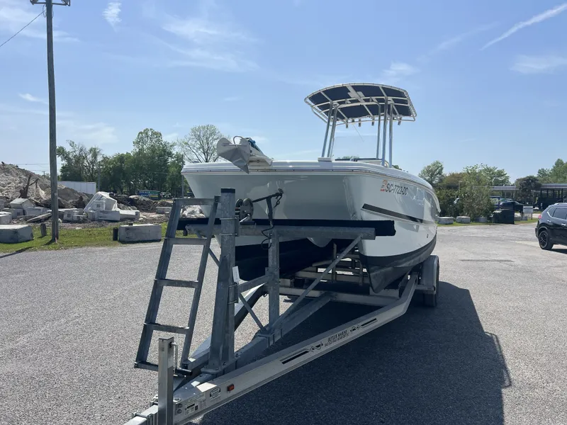 Slide: The Image of 2015 Carolina Cat 23CC boat on trailer outdoors. - 13