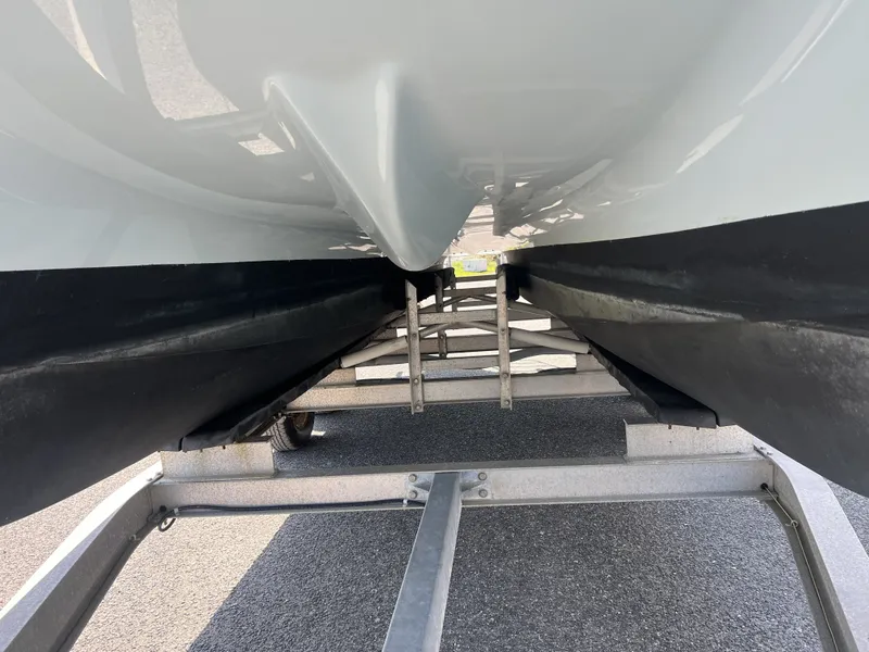 Slide: The Image of Underside of a Carolina Cat 23CC boat on a trailer. - 15