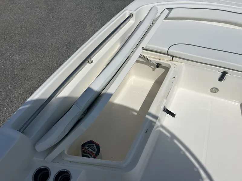 Slide: The Image of 2015 Carolina Cat 23CC boat deck with storage compartment and cup holders. - 3