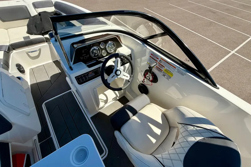 Slide: The Image of 2023 Bayliner DX 2050 boat interior with steering wheel and seating. - 10
