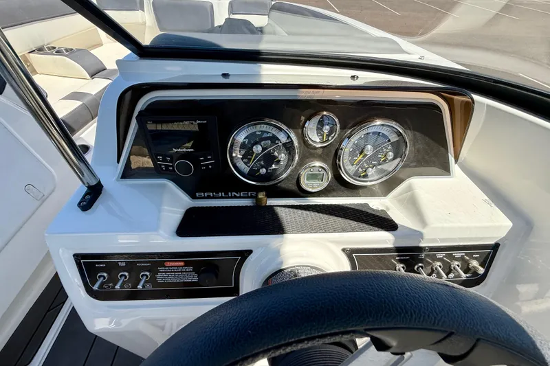 Slide: The Image of Dashboard of 2023 Bayliner DX 2050 boat with gauges and controls. - 11
