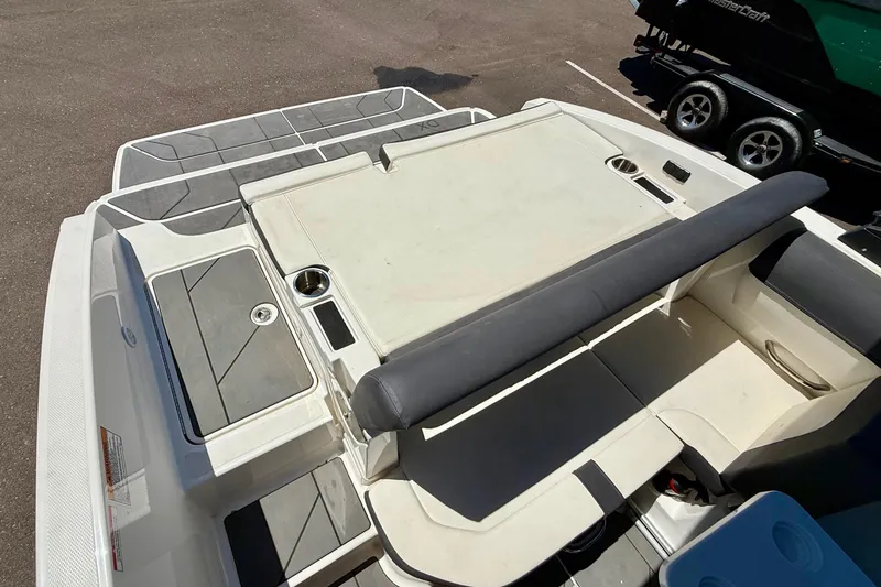 Slide: The Image of 2023 Bayliner DX 2050 boat interior with seating and storage compartments. - 13