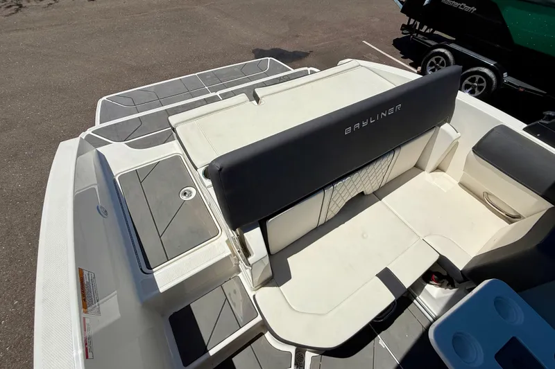 Slide: The Image of 2023 Bayliner DX 2050 boat interior with seating and storage compartments. - 14