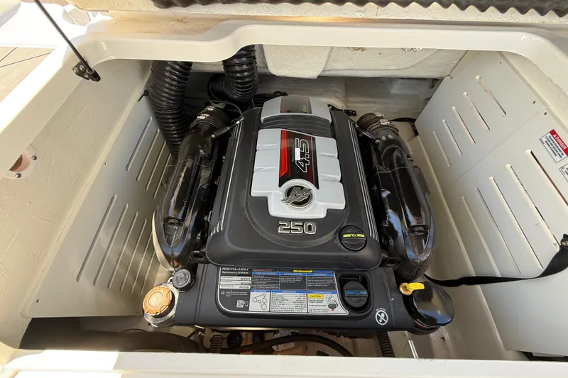 Slide: The Image of Engine compartment of 2023 Bayliner DX 2050 boat, featuring a powerful 250 horsepower engine. - 15