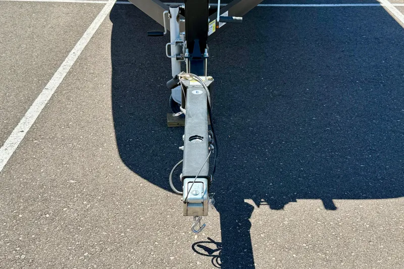 Slide: The Image of Trailer hitch of a 2023 Bayliner DX 2050 boat on asphalt. - 25