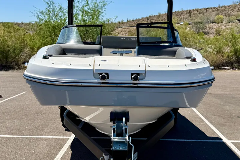 Slide: The Image of 2023 Bayliner DX 2050 boat on trailer in sunny outdoor setting. - 26